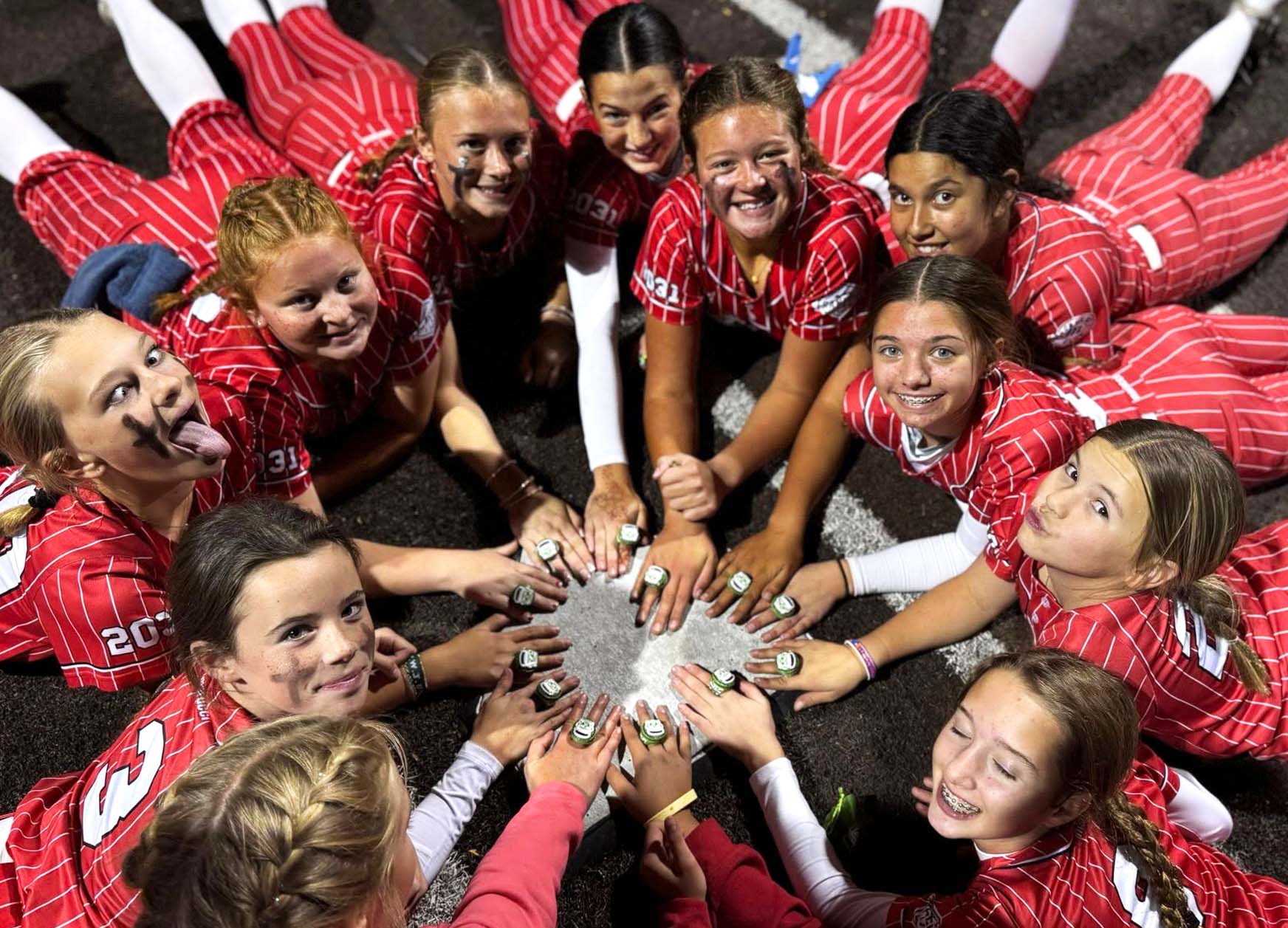Colorado Angels 12U Odell show off their rings as champions.