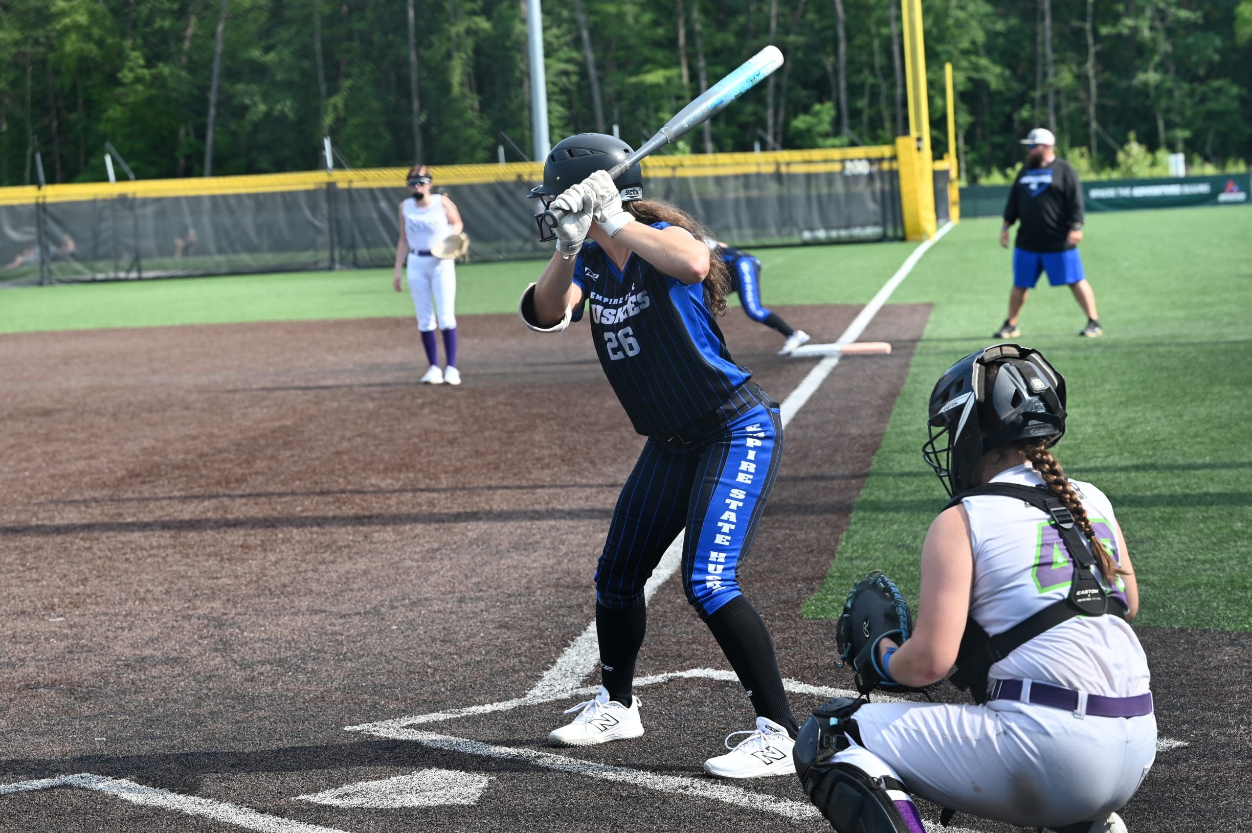 Laurel Pucci prepares to hit from the left side during a showcase matchup. Her recent transition to left-handed hitting highlights her commitment to growth at the plate.