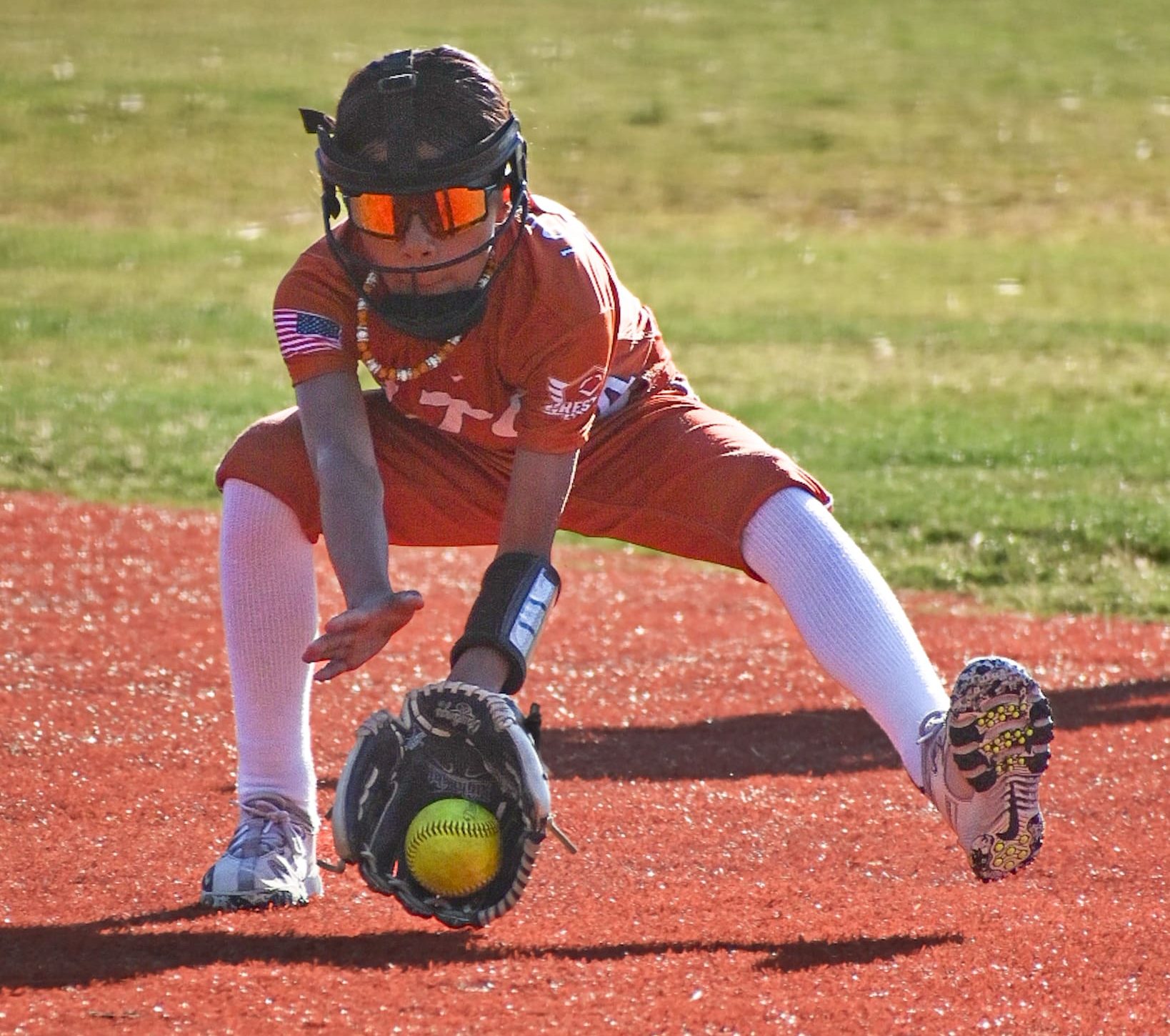 Aaliyah Lomas of LTG Lions Mora/Sousa fields a ground ball during infield warmups at a 10U travel tournament.