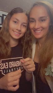 Izzy and her close friend Leilani, softball teammates and off-the-field family, share a moment before game day.