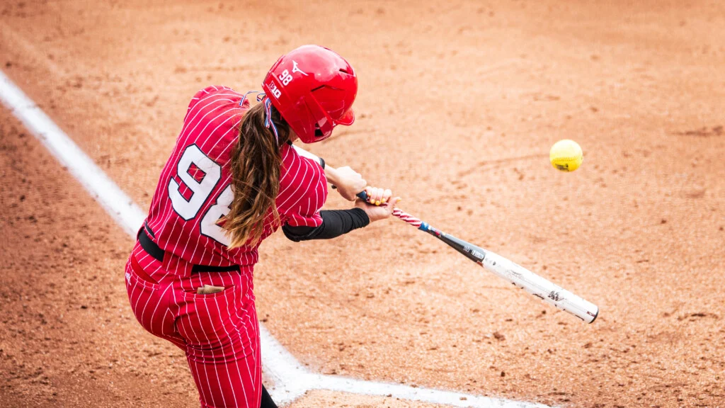 Jordy Frahm squares up a pitch at the plate, highlighting her impact as a two-way player.