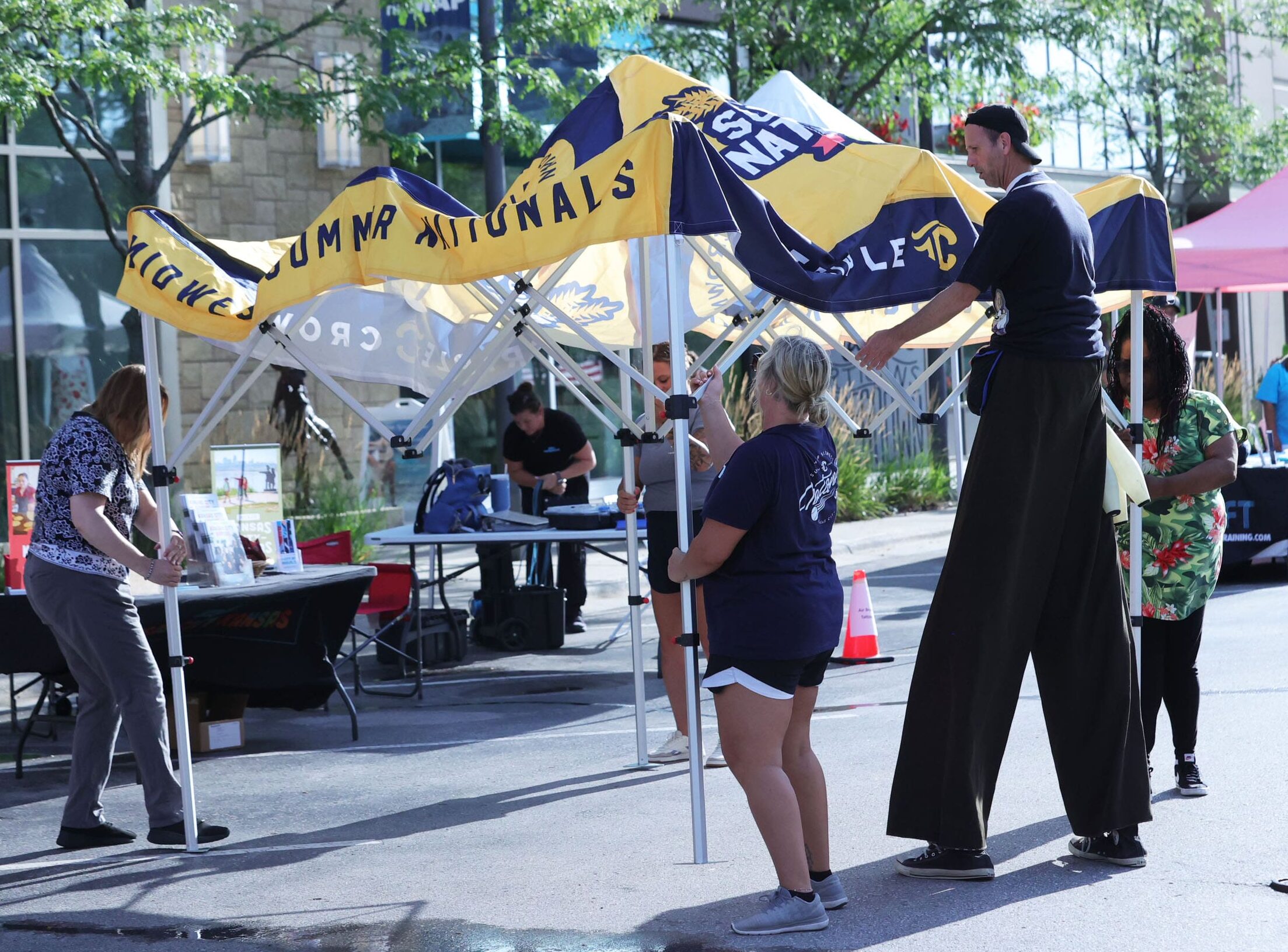 Staff members prepare event tents ahead of activities during the Midwest Summer Nationals championship week.