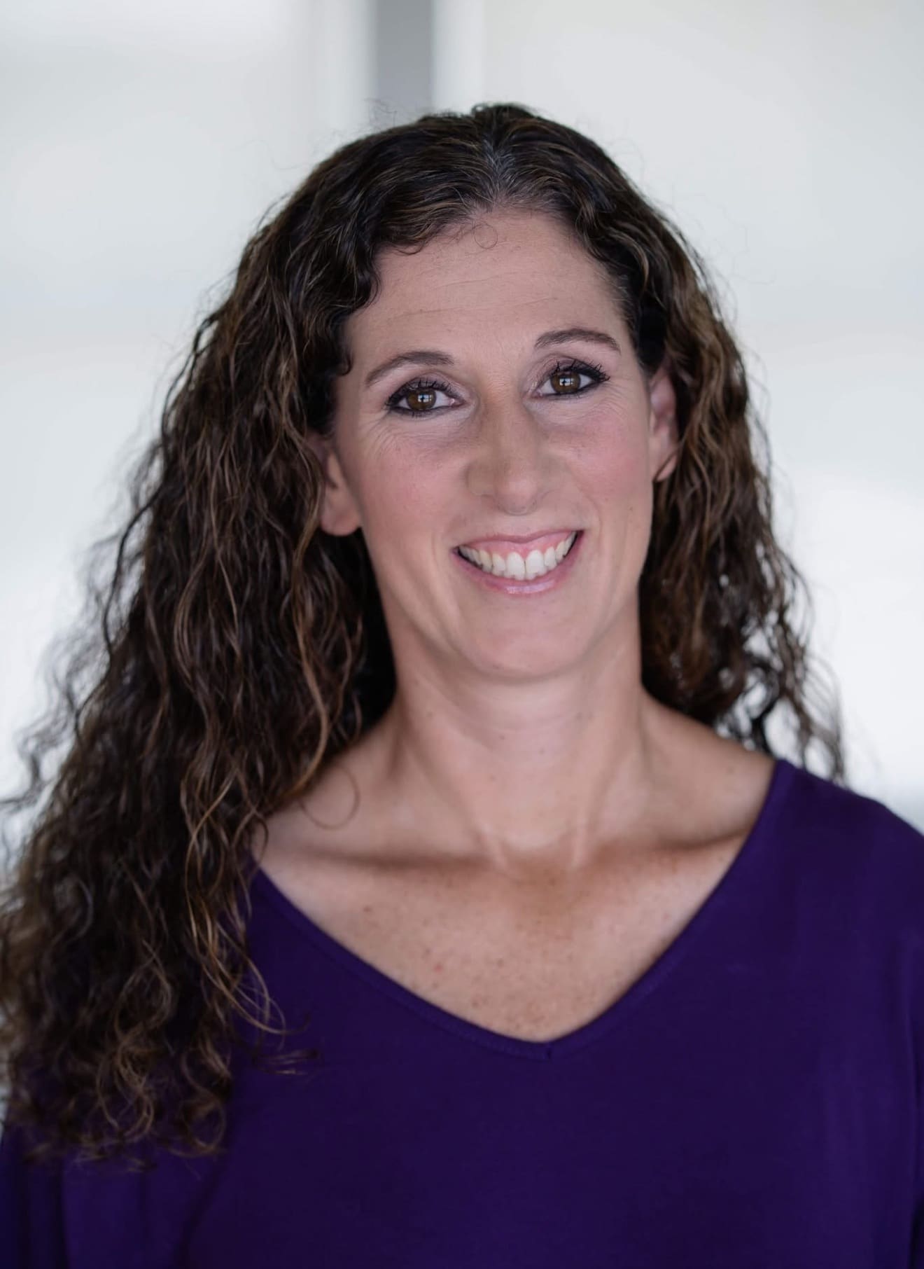 Amy Suiter smiles during an indoor portrait session.
