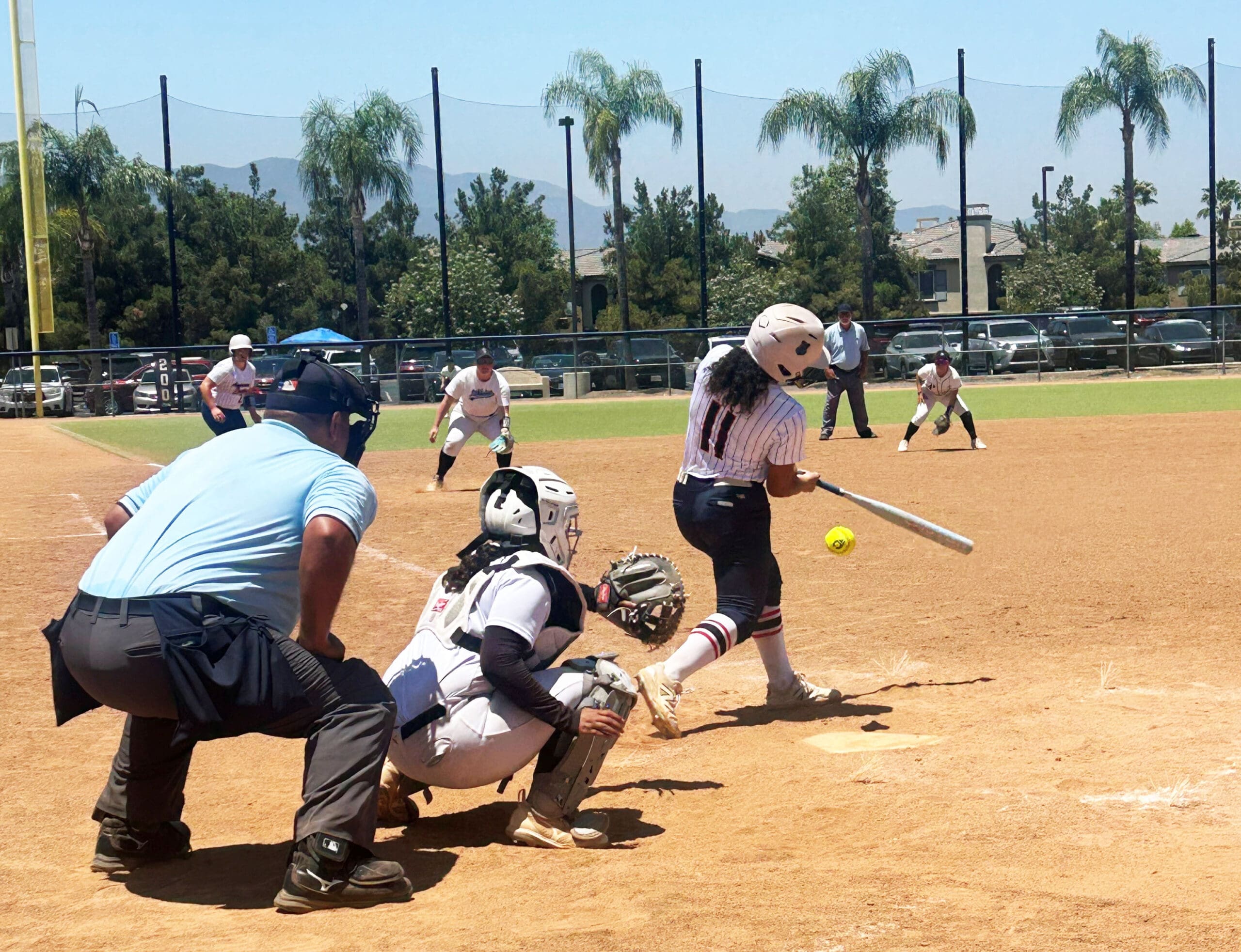 A hitter makes contact during showcase play at the Zoom Into June tournament in Southern California.
