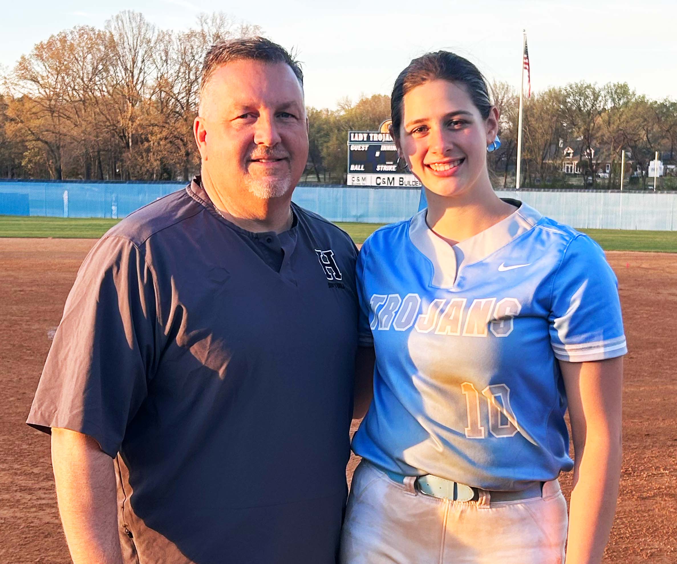 Ada Woodruff, Class of 2026 pitcher and utility player for MS Glory 18U National, stands with Head Coach Jim Lewis.