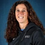 Amy Suiter poses for a portrait in a WWU softball jacket.