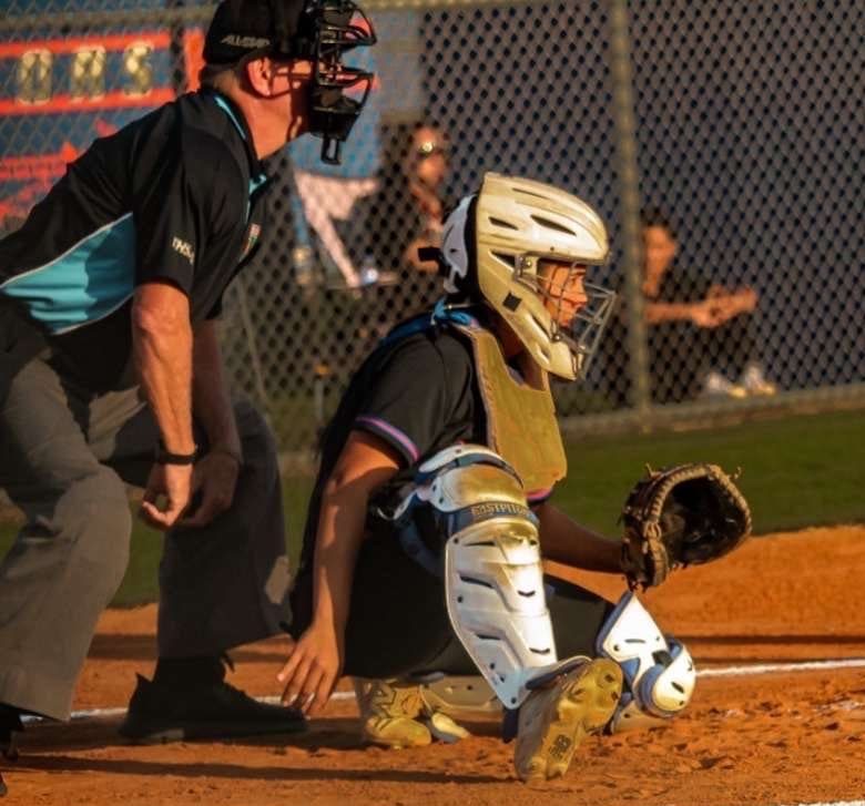 Angelina Rodriguez, Class of 2026, sets up behind the plate during a game with her 18U club team. Rodriguez is known for her defensive leadership and strong game presence.