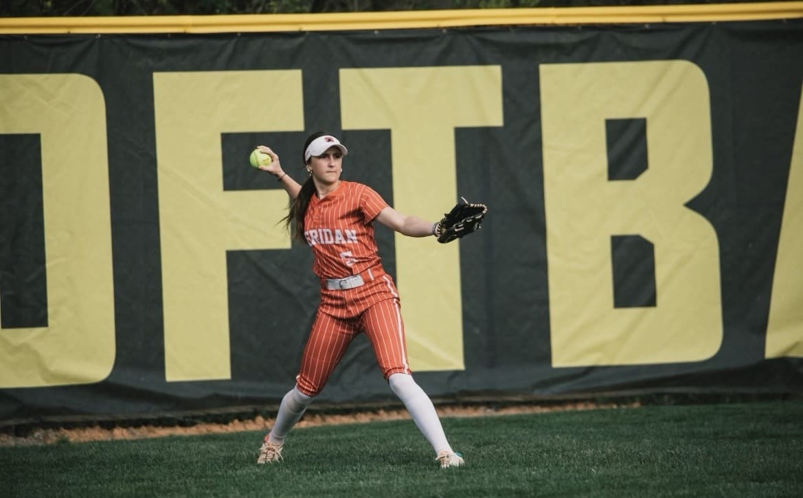 Sheridan High School outfielder Lakelyn Haas prepares to throw during a varsity softball game.